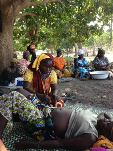 A Senegalese midwife performing a prenatal checkup